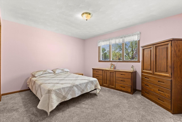 636 Westbury Ln Unit 12, Delavan, WI 53115 - bedroom with light colored carpet and baseboards
