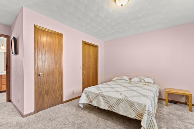 636 Westbury Ln Unit 12, Delavan, WI 53115 - bedroom with carpet floors and baseboards