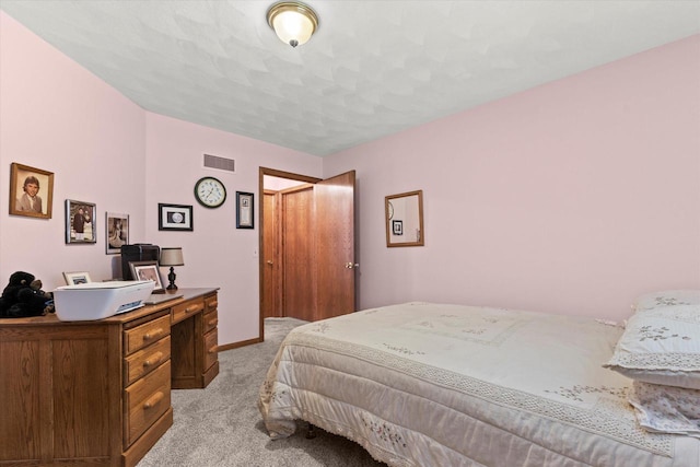 636 Westbury Ln Unit 12, Delavan, WI 53115 - bedroom with light carpet, a desk, and baseboards