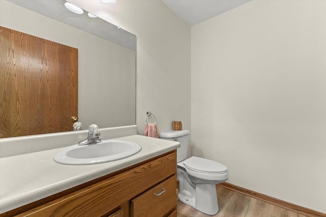 636 Westbury Ln Unit 12, Delavan, WI 53115 - bathroom featuring vanity, toilet, and wood finished floors