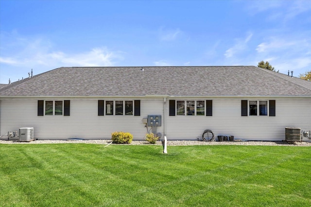 636 Westbury Ln Unit 12, Delavan, WI 53115 - back of house featuring central AC, a yard, and a shingled roof