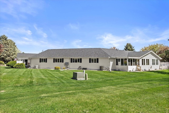 636 Westbury Ln Unit 12, Delavan, WI 53115 - rear view of property featuring a lawn and central AC