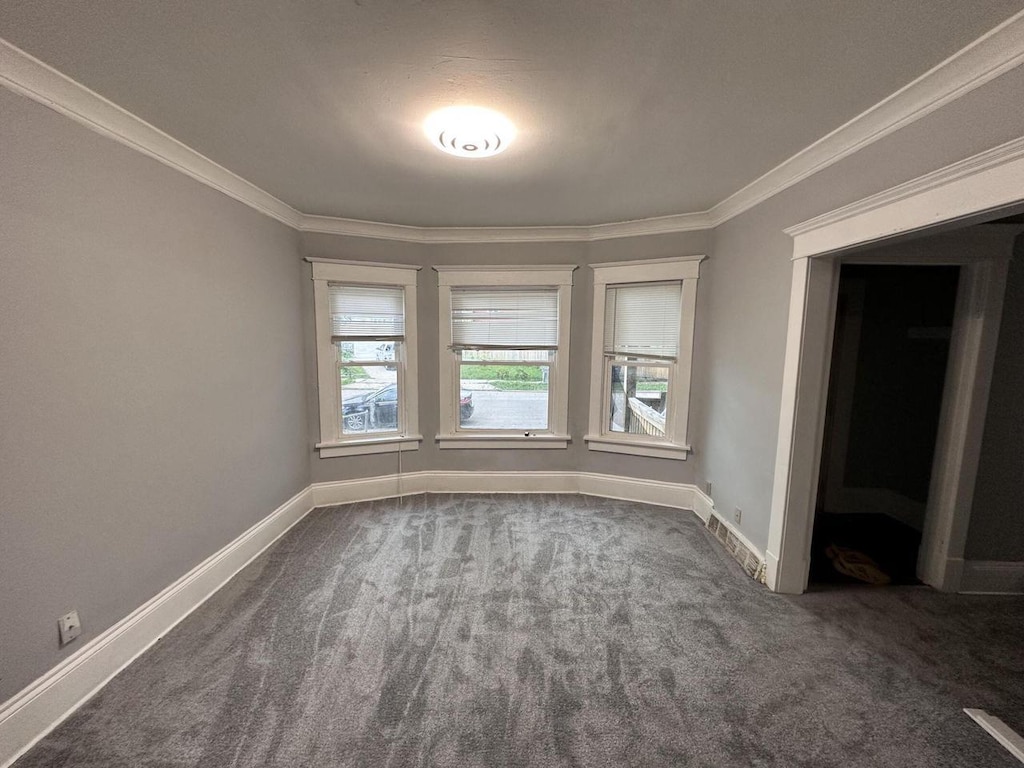 1950 N 40th St Unit 1952, Milwaukee, WI 53208 - spare room featuring dark carpet, ornamental molding, and baseboards
