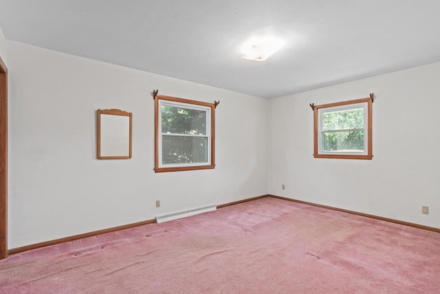 11549 N Meadowbrook Dr, Mequon, WI 53097 - spare room featuring a baseboard heating unit, healthy amount of natural light, carpet flooring, and baseboards