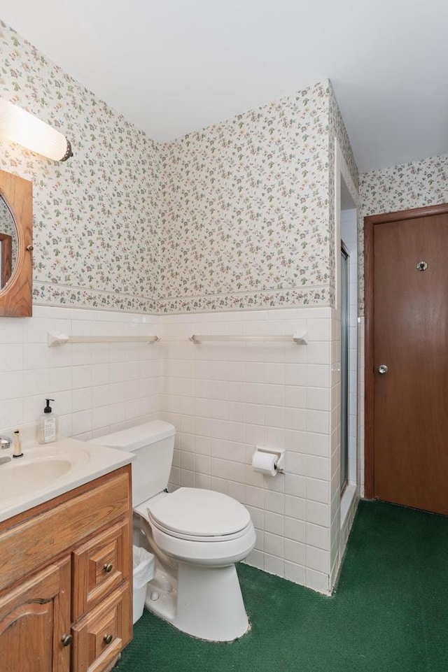 11549 N Meadowbrook Dr, Mequon, WI 53097 - bathroom with wallpapered walls, a stall shower, wainscoting, vanity, and toilet
