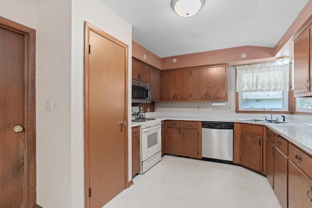 11549 N Meadowbrook Dr, Mequon, WI 53097 - kitchen featuring stainless steel appliances, a sink, light countertops, light flooring, and brown cabinets