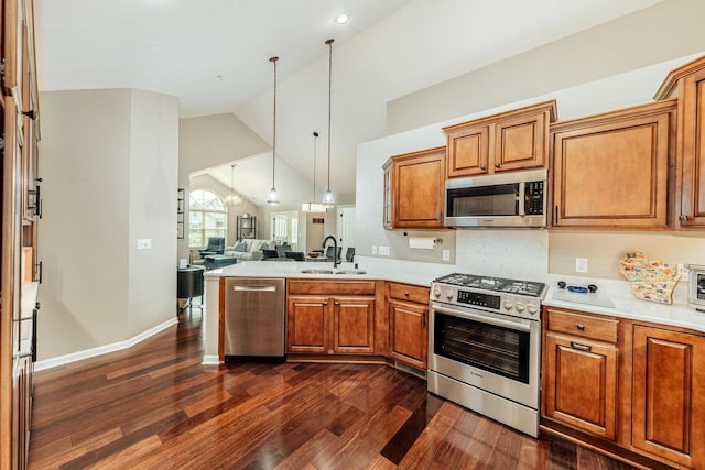 15370 Huff Way, Brookfield, WI 53005 - kitchen with appliances with stainless steel finishes, open floor plan, a sink, dark wood-style flooring, and brown cabinetry