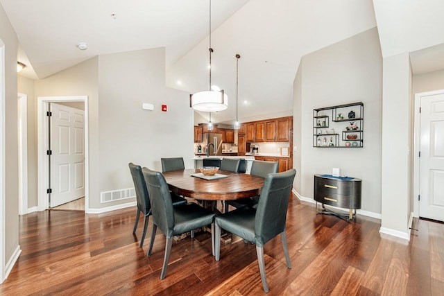 15370 Huff Way, Brookfield, WI 53005 - dining area featuring vaulted ceiling, dark wood-style floors, and baseboards