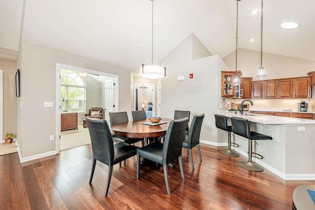 15370 Huff Way, Brookfield, WI 53005 - dining room with dark wood-style floors, baseboards, high vaulted ceiling, and ceiling fan