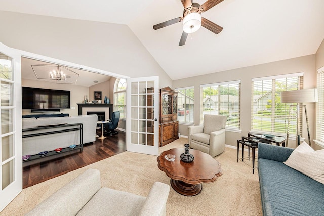 15370 Huff Way, Brookfield, WI 53005 - living area featuring plenty of natural light, a fireplace, a chandelier, a ceiling fan, and high vaulted ceiling