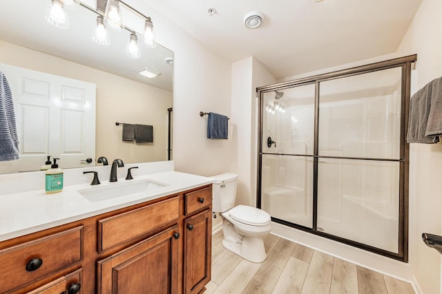 15370 Huff Way, Brookfield, WI 53005 - full bathroom featuring toilet, a stall shower, vanity, and wood finished floors