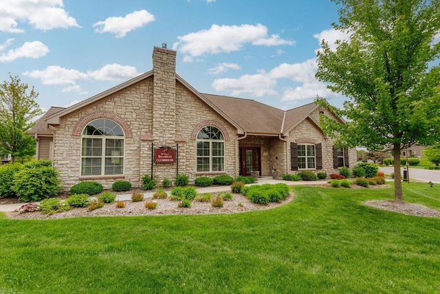 15370 Huff Way, Brookfield, WI 53005 - view of front of house featuring stone siding, a chimney, a front yard, and roof with shingles