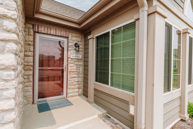 15370 Huff Way, Brookfield, WI 53005 - view of exterior entry featuring stone siding and a shingled roof