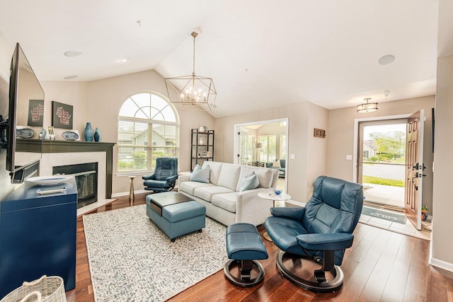 15370 Huff Way, Brookfield, WI 53005 - living room with wood finished floors, a chandelier, lofted ceiling, a fireplace with flush hearth, and baseboards