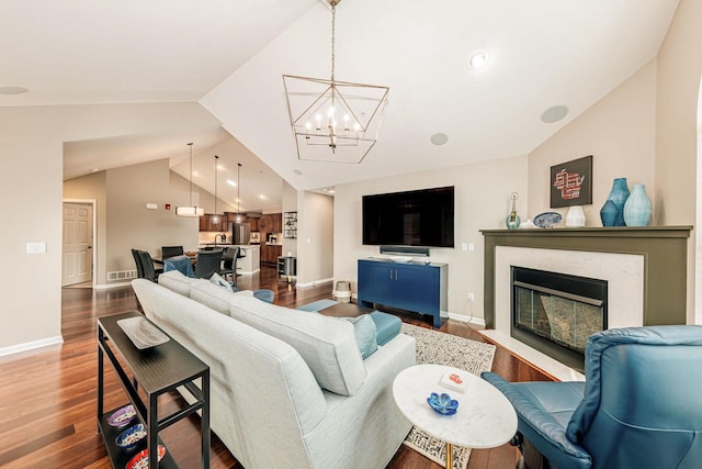 15370 Huff Way, Brookfield, WI 53005 - living room with vaulted ceiling, dark wood-style floors, a chandelier, a fireplace with flush hearth, and baseboards