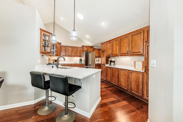 15370 Huff Way, Brookfield, WI 53005 - kitchen with high end refrigerator, brown cabinetry, a sink, a peninsula, and glass insert cabinets