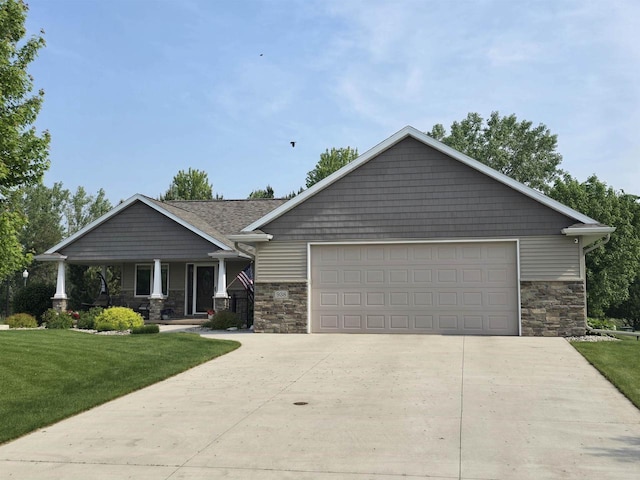 938 W Northstar Dr, Appleton, WI 54913 - craftsman inspired home featuring stone siding, driveway, a front lawn, and covered porch