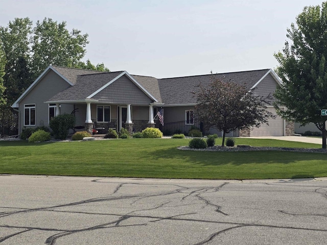 938 W Northstar Dr, Appleton, WI 54913 - view of front of property featuring a front yard, stone siding, covered porch, a garage, and driveway