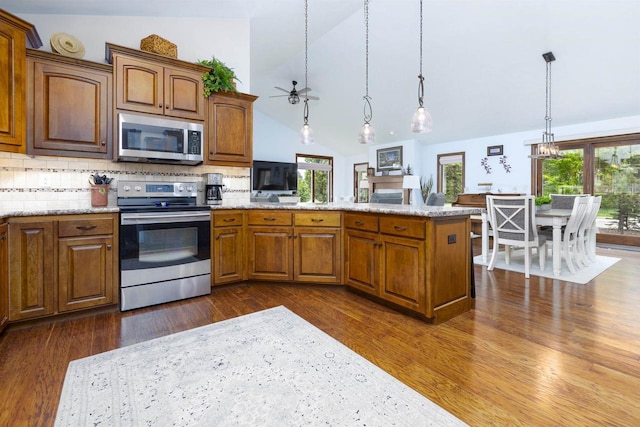 938 W Northstar Dr, Appleton, WI 54913 - kitchen with stainless steel appliances, a peninsula, dark wood-type flooring, a ceiling fan, and light stone counters