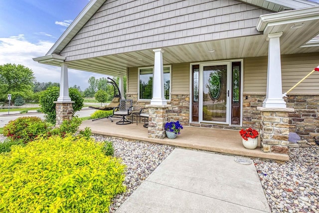 938 W Northstar Dr, Appleton, WI 54913 - doorway to property with covered porch and stone siding