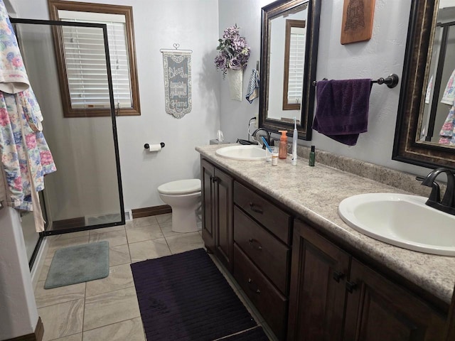 938 W Northstar Dr, Appleton, WI 54913 - bathroom with a shower stall, double vanity, toilet, baseboards, and tile patterned floors