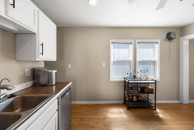1568 S 63rd St, West Allis, WI 53214 - kitchen with dishwasher, a sink, light wood finished floors, and white cabinetry