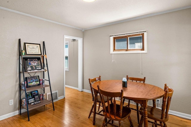 1568 S 63rd St, West Allis, WI 53214 - dining room featuring crown molding, hardwood / wood-style flooring, and baseboards