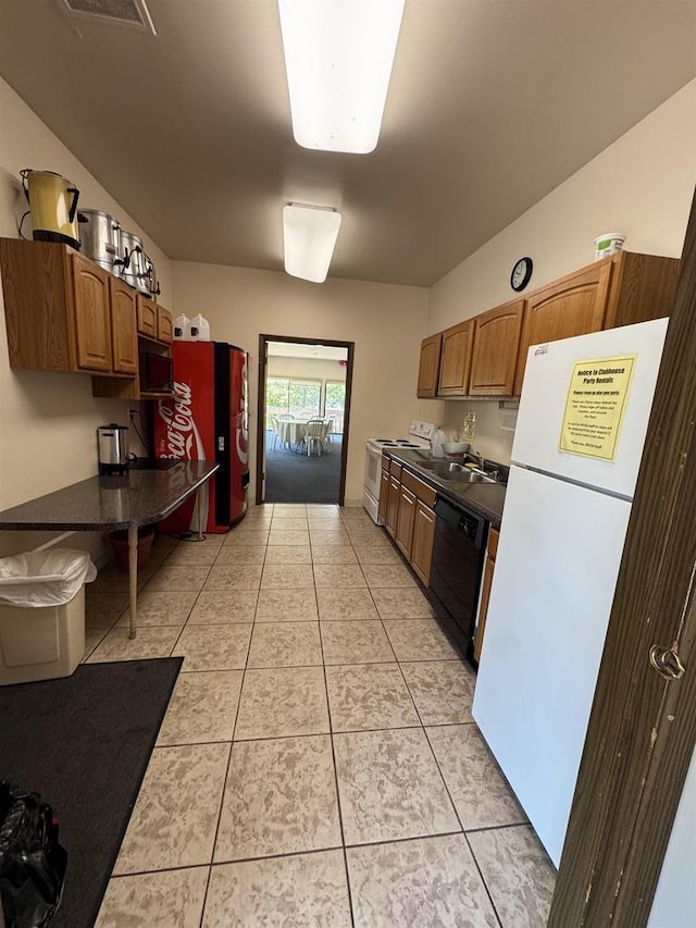 2470 W Good Hope Rd Unit 168, Glendale, WI 53209 - kitchen with white appliances, dark countertops, light tile patterned floors, and brown cabinetry