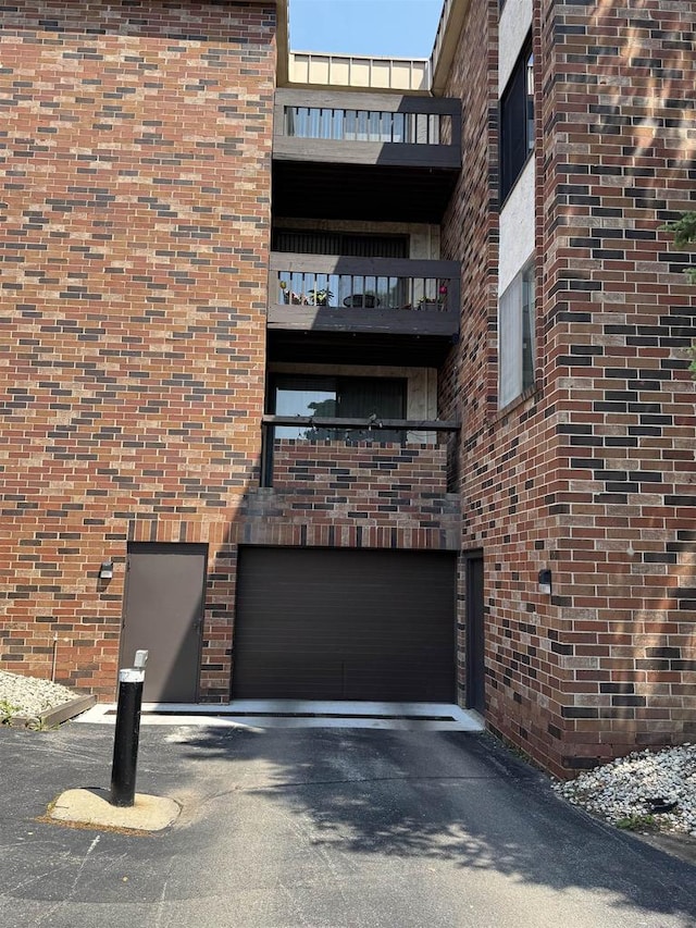 2470 W Good Hope Rd Unit 168, Glendale, WI 53209 - view of property featuring a garage and asphalt driveway