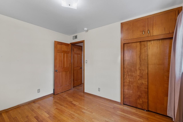 2943 S 102nd St, West Allis, WI 53227 - unfurnished bedroom with a closet, baseboards, and light wood-type flooring