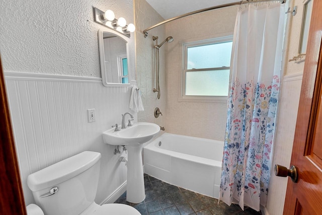 2943 S 102nd St, West Allis, WI 53227 - full bathroom featuring toilet, shower / bath combo, tile patterned flooring, wainscoting, and a sink