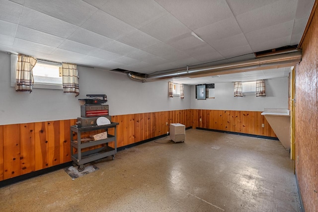 2943 S 102nd St, West Allis, WI 53227 - basement featuring tile patterned floors, wooden walls, a wainscoted wall, and electric panel