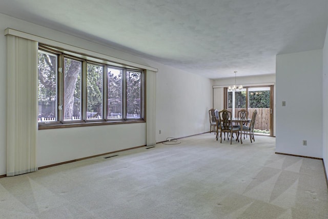 1016 E Marnie Ln, Appleton, WI 54911 - spare room featuring a chandelier, carpet floors, and baseboards