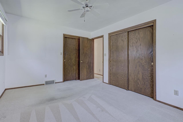 1016 E Marnie Ln, Appleton, WI 54911 - unfurnished bedroom with carpet floors, multiple closets, baseboards, and a ceiling fan