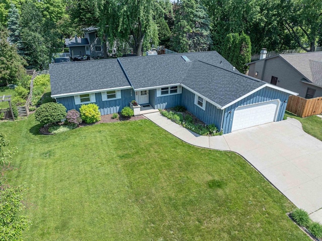 1016 E Marnie Ln, Appleton, WI 54911 - view of front facade featuring a garage, roof with shingles, board and batten siding, and driveway