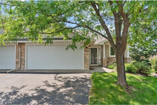 1102 Highpoint Ct, New Richmond, WI 54017 - view of front facade with stone siding and asphalt driveway