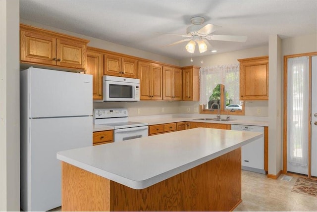 1102 Highpoint Ct, New Richmond, WI 54017 - kitchen with white appliances, a sink, light countertops, ceiling fan, and a kitchen island