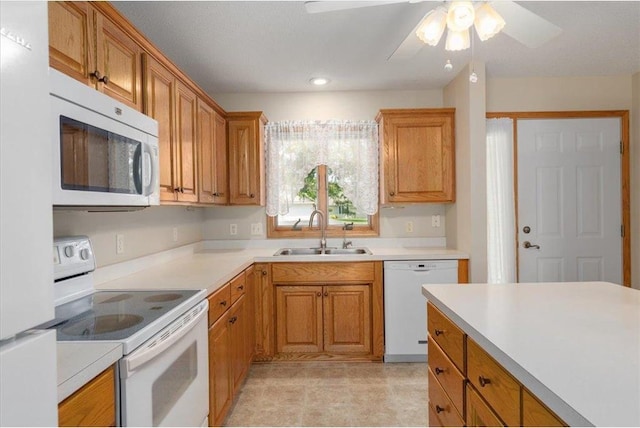 1102 Highpoint Ct, New Richmond, WI 54017 - kitchen with white appliances, a sink, light countertops, ceiling fan, and brown cabinets