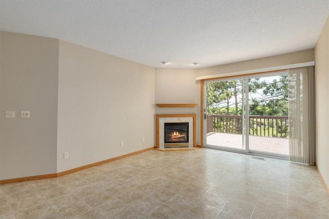 1102 Highpoint Ct, New Richmond, WI 54017 - unfurnished living room featuring a warm lit fireplace, baseboards, and a textured ceiling