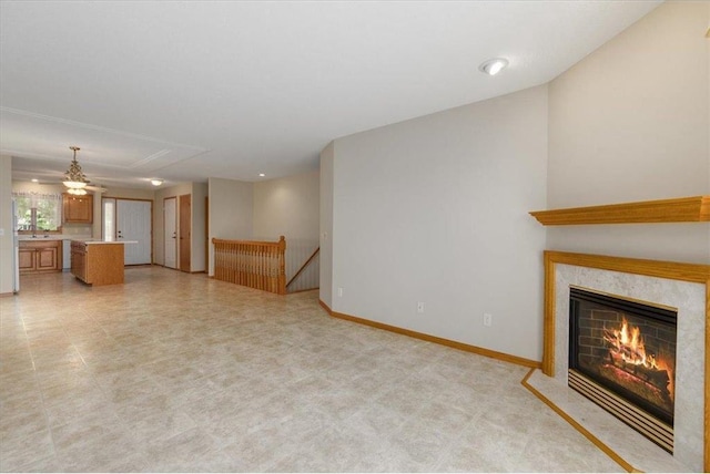 1102 Highpoint Ct, New Richmond, WI 54017 - unfurnished living room featuring a premium fireplace and baseboards