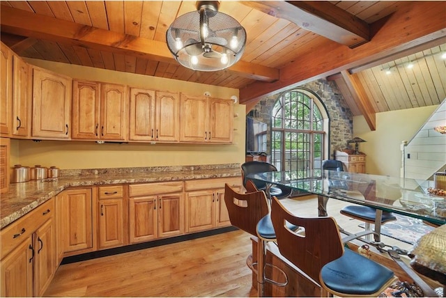 W11333 862nd St, River Falls, WI 54022 - kitchen featuring wooden ceiling, light wood finished floors, a chandelier, light stone countertops, and arched walkways