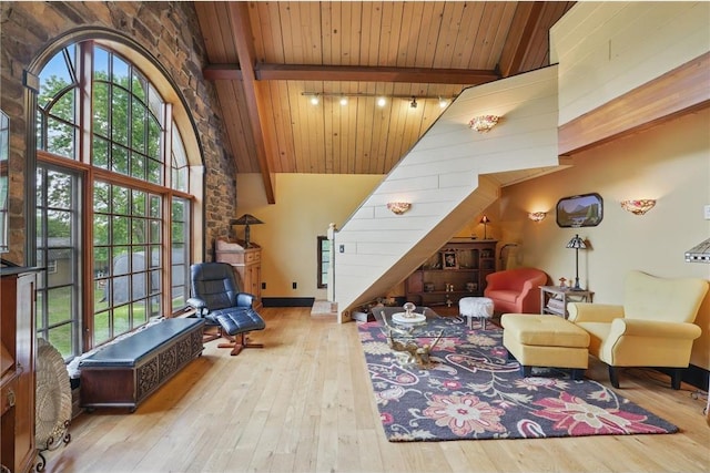 W11333 862nd St, River Falls, WI 54022 - living area with hardwood / wood-style floors, high vaulted ceiling, wood ceiling with exposed beams, and stairs