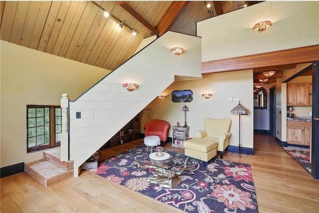 W11333 862nd St, River Falls, WI 54022 - living room with wood finished floors, baseboards, wood ceiling with exposed beams, high vaulted ceiling, and stairs