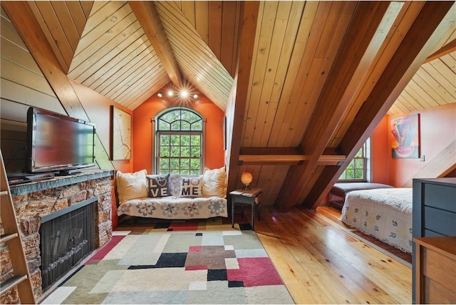 W11333 862nd St, River Falls, WI 54022 - bedroom with hardwood / wood-style floors, a stone fireplace, and wooden ceiling