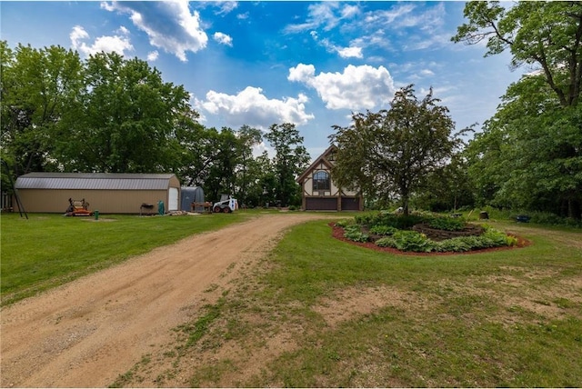 W11333 862nd St, River Falls, WI 54022 - view of grassy yard with dirt driveway, an outdoor structure, and view of scattered trees