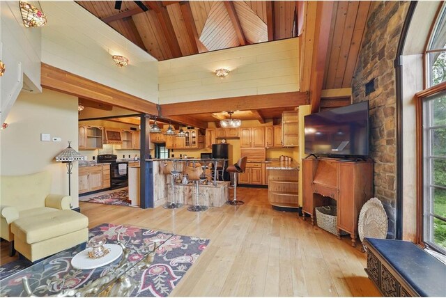 W11333 862nd St, River Falls, WI 54022 - living room with light wood-type flooring, wooden ceiling with exposed beams, high vaulted ceiling, and a chandelier