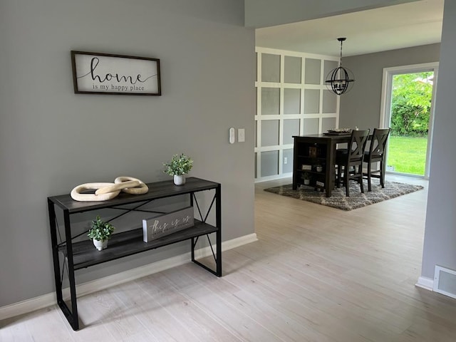 233 Inlet Shores Dr, Delavan, WI 53115 - hall with baseboards, wood finished floors, and a chandelier