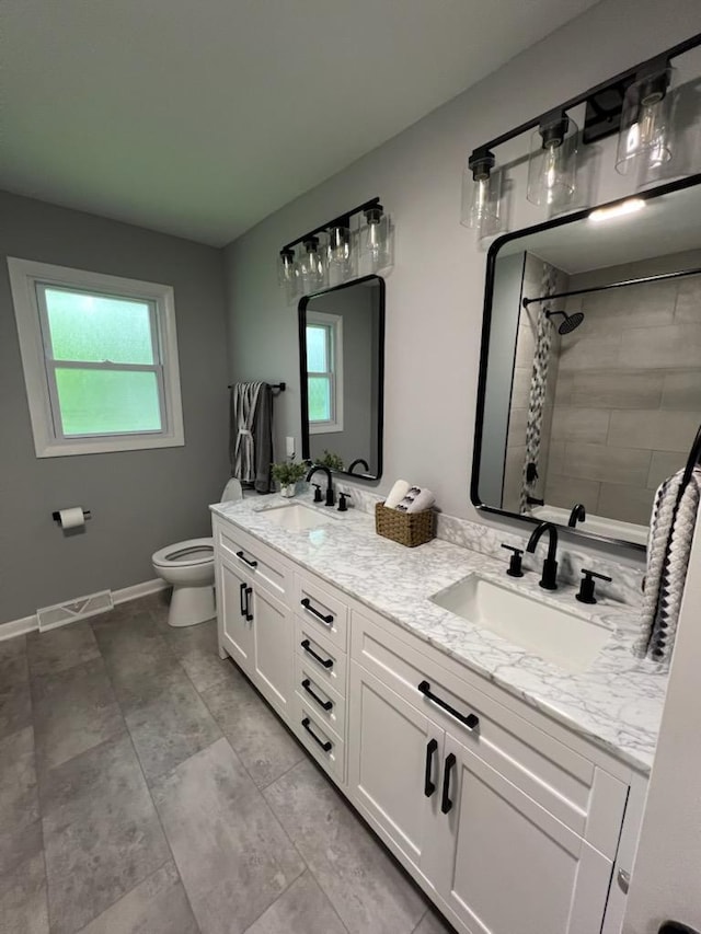 233 Inlet Shores Dr, Delavan, WI 53115 - full bath with plenty of natural light, double vanity, toilet, and tiled shower