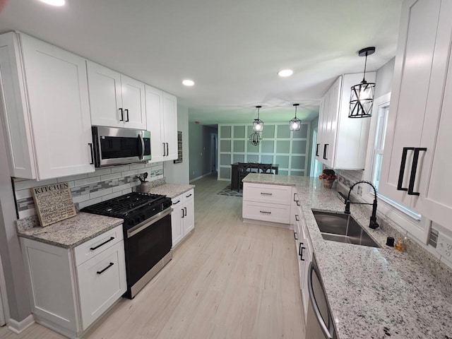 233 Inlet Shores Dr, Delavan, WI 53115 - kitchen featuring appliances with stainless steel finishes, a sink, backsplash, white cabinets, and recessed lighting
