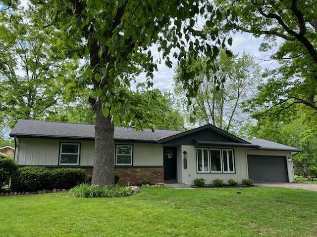 233 Inlet Shores Dr, Delavan, WI 53115 - single story home with a garage, concrete driveway, a front yard, and brick siding